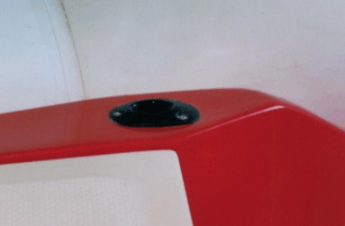 Fishing rod base beside the case-seat trimmed by the bow